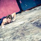 Nico is climbing a high promplem in Ticino, Switzerland