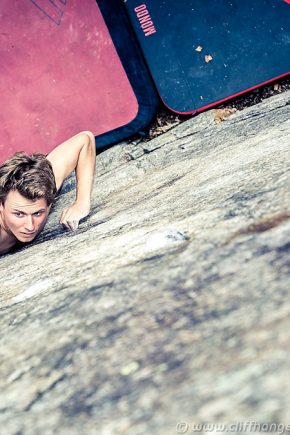 Nico is climbing a high promplem in Ticino, Switzerland